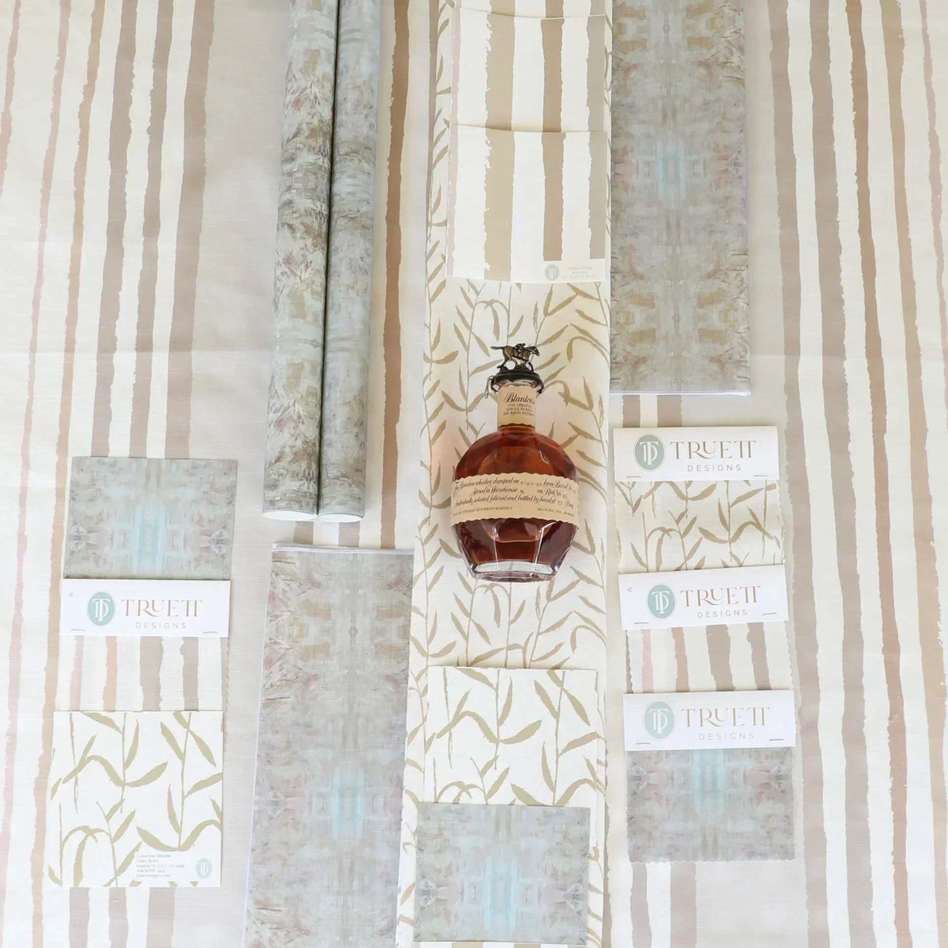 Luxury botanical fabric in warm brass tones with layered painterly organic design, ideal for upholstery, drapery, and sophisticated contemporary interiors.