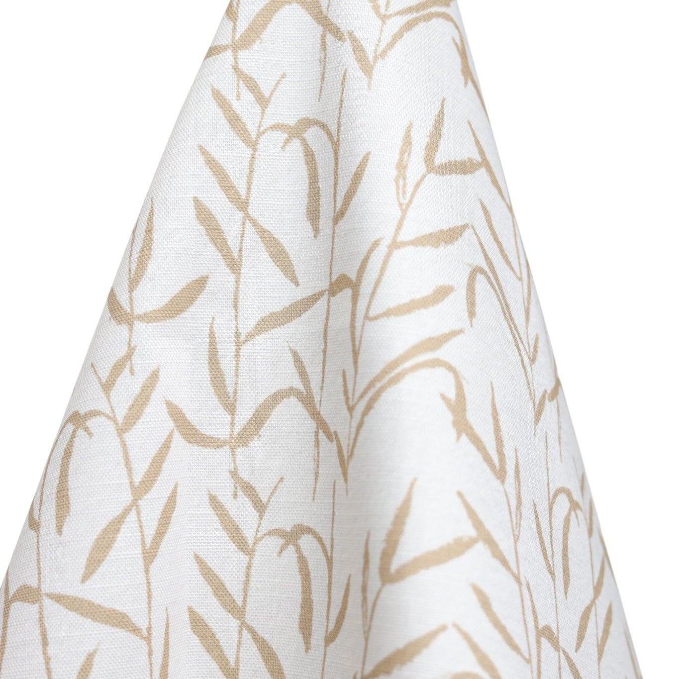 Luxury botanical fabric in warm brass tones with layered painterly organic design, ideal for upholstery, drapery, and sophisticated contemporary interiors.