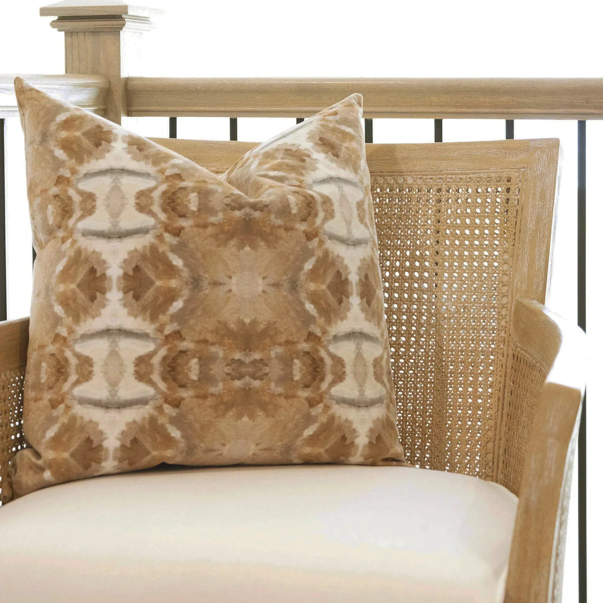 Luxury decorative pillow featuring an organic tree-inspired pattern in warm cognac and neutral tones, styled for a layered modern traditional interior.