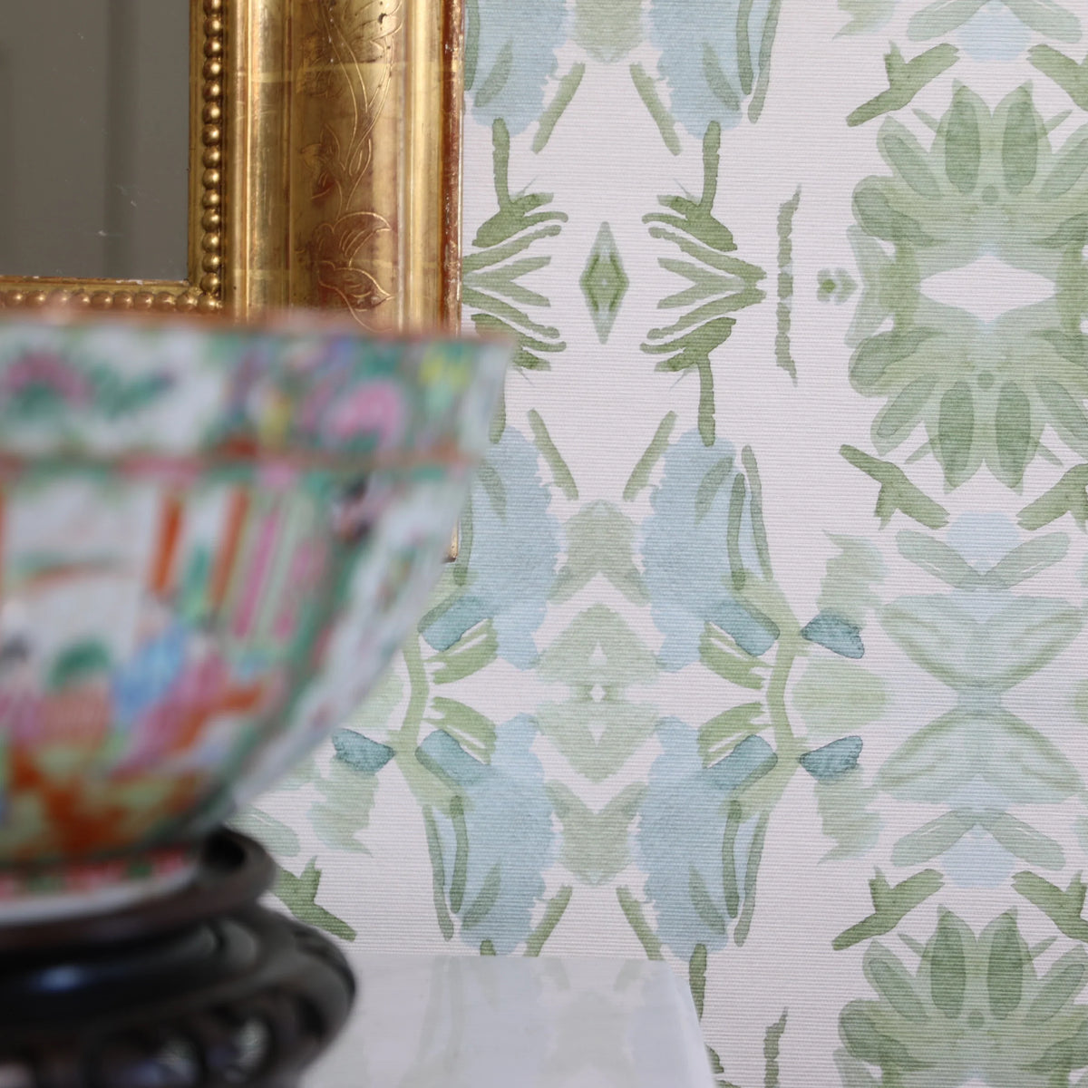 Luxury botanical wallpaper featuring an artistic wildflower-inspired pattern in sage green and soft blue, designed for modern traditional interiors, powder rooms, bedrooms, dining rooms, and collected homes.