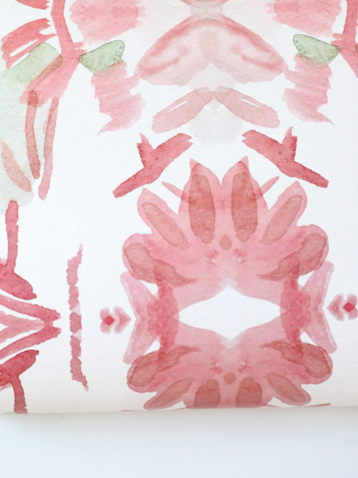 Luxury floral wallpaper featuring an artistic wildflower pattern in strawberry pink, blush, and soft green tones, designed for modern traditional interiors, bedrooms, powder rooms, and collected homes.