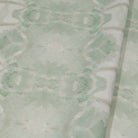 Luxury abstract botanical fabric featuring layered tree-inspired movement in calming jade green and soft neutral tones for collected modern traditional interiors.