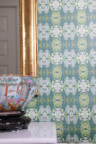 Luxury abstract floral wallpaper in rich dark green tones with layered organic movement, designed for modern traditional and collected interiors.