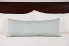 Luxury floral bolster pillow featuring a delicate cottage garden pattern with soft botanical detail, handcrafted in England for timeless and layered interiors.