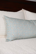 Luxury floral bolster pillow featuring a delicate cottage garden pattern with soft botanical detail, handcrafted in England for timeless and layered interiors.