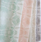 Luxury abstract botanical fabric featuring layered tree-inspired movement in calming jade green and soft neutral tones for collected modern traditional interiors.